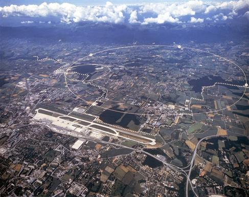 Aerial view of the CERN site just outside Geneva. The underground particle accelerators (with circumferences of 27 km and 7 km) allow scientists to look at tiny scales. Image &copy; <a href='http://public.web.cern.ch/Public/Welcome.html'>CERN</a>.