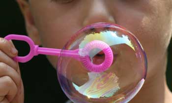A boy blowing a soap bubble