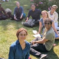 Participants at the "Use of Modelling" workshop - day 2 - sitting on the grass in the sunshine