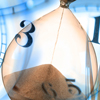 hourglass with clock behind