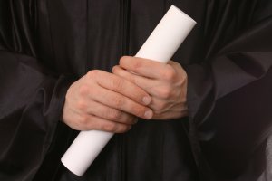 hands holding a graduation certificate