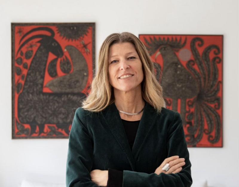 Woman standing in front of paintings