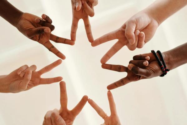 7 hands making a seven pronged star