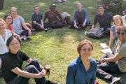 Participants at the "Use of Modelling" workshop - day 2 - sitting on the grass in the sunshine