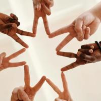 7 hands making a seven pronged star