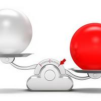 Red and white ball on scales